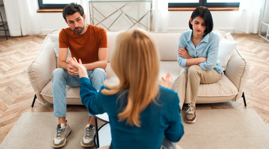 Couple in a therapy session working with a counselor to improve communication and rebuild their relationship