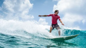 Image of a man riding the wave Is Surf Therapy for Veterans Effective - South Shores Recovery